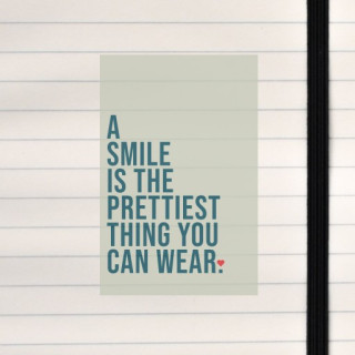 A clean, uplifting quote layout reminding that a smile is the most beautiful thing you can wear.
