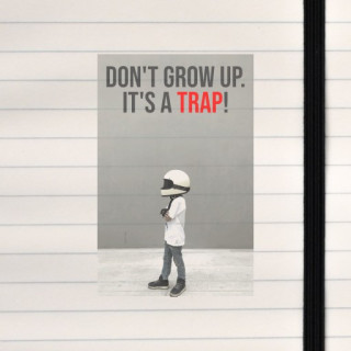 A bold, humorous design featuring a kid wearing a helmet, directed to anyone who refuses to take adulthood too seriously.