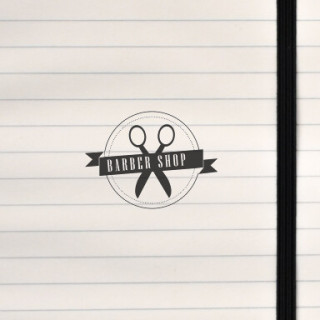 A vintage circular badge featuring crossed scissors and bold lettering.