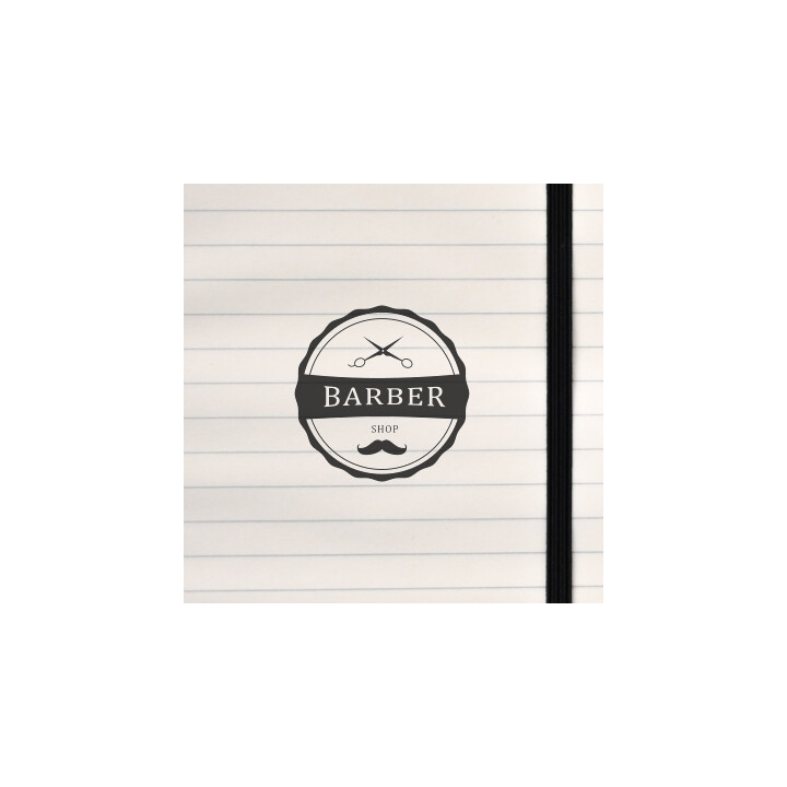 A vintage circular badge with scissors, mustache, and bold lettering.
