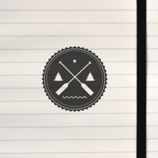 A circular nature emblem with crossed paddles, trees, and water.