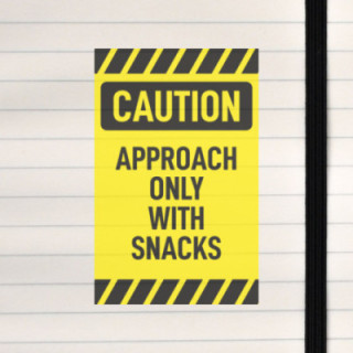A playful warning sign demanding snacks before entry.