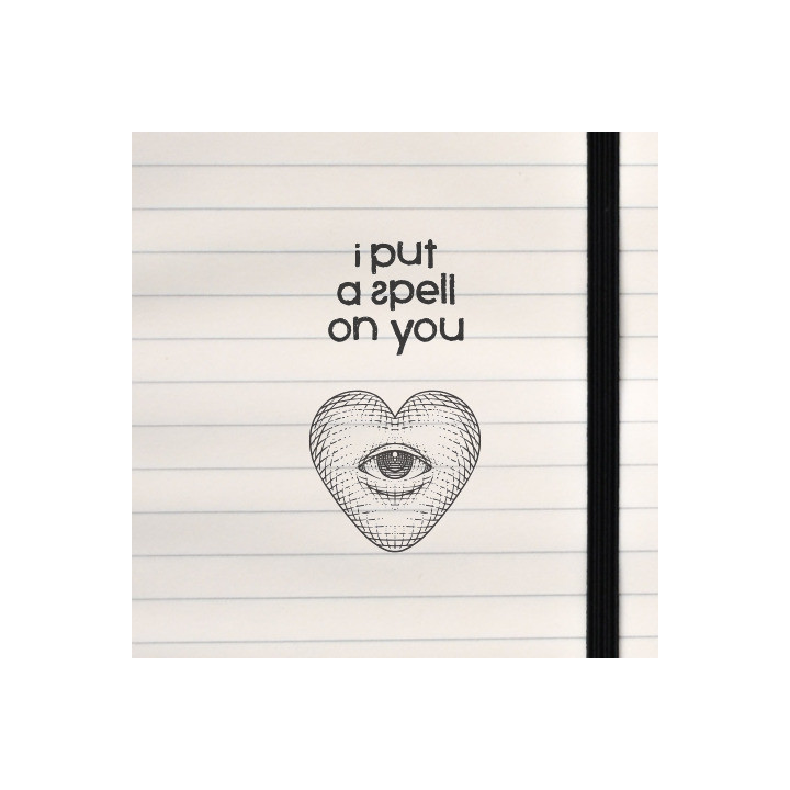 A mystical and surreal design featuring the phrase “I put a spell on you” paired with a heart-shaped eye illustration, printed o