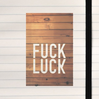Fuck luck on a wooden background.