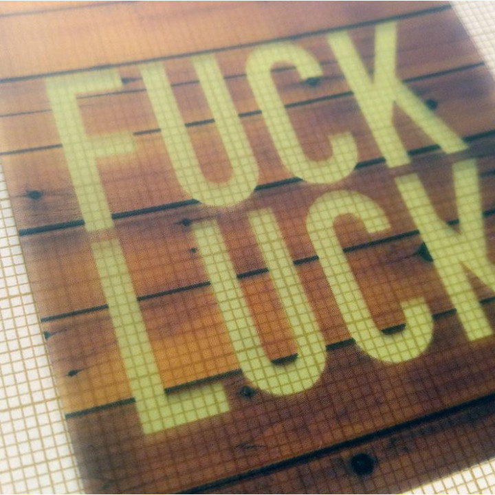 Fuck luck on a wooden background.