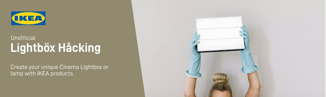 Woman holding a blank lightbox into the air.
